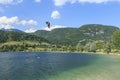 Bohinj, Slovenia - June 4, 2017: Tourist paragliding on lake Bohinj a famous destination not far from lake Bled, in Slovenia