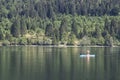 Bohinj, Slovenia - June 4, 2017: Tourist on a small boat in lake Bohinj, a famous destination not far from lake Bled.