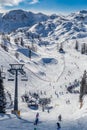 Bohinj, Slovenia - Winter view of snowy mountain Vogel with skiers on ski slopes and ski lift in the Alps at Triglav National Park Royalty Free Stock Photo