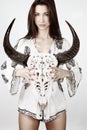 Boho girl holding a buffalo head skeleton