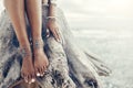 Boho girl wearing indian silver jewelry on the beach