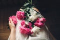 Boho girl in white bohemia dress holding beautiful pink peonies on legs, top view. space for text. stylish hipster woman with Royalty Free Stock Photo