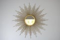 Boho mirror sun shape. Sun-shaped mirror in interior Royalty Free Stock Photo