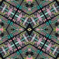 Boho patchwork flower pattern with a gypsy retro style. Repeatable vintage cloth effect print in black and red gothic