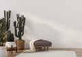 Boho-style interior with leather pouf and cacti