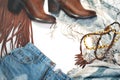 Boho Style. Leather Boots, Denim and Bag with Fringe on White Background. Overhead View Casual Day Outfits. Trendy Look.