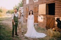 Boho-style newlyweds standing near horse on ranch Royalty Free Stock Photo