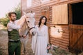 Boho-style newlyweds standing near horse on ranch Royalty Free Stock Photo