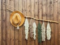 Boho style wall decor with a straw hat and macrame hanging on a wooden background. Cozy rustic interior decoration with Royalty Free Stock Photo