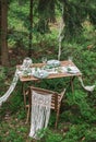 Boho style wedding reception dinning table with macrame tablecloth Royalty Free Stock Photo