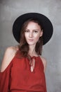 Boho style woman in studio staying near brick wall