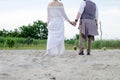 Boho wedding couple. Back view. Stylish hippie woman in white ethnic dress Royalty Free Stock Photo