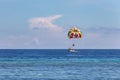 Two people parasailing in blue sea, blue sky Royalty Free Stock Photo