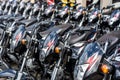 Bohol, Philippines - Rows of Kawasaki Bajaj 125 motorcycles for sale at a dealership. Motorbikes at an outdoor lot