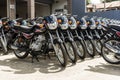 Bohol, Philippines - Rows of Kawasaki Bajaj 125 motorcycles for sale at a dealership. Motorbikes at an outdoor lot