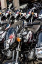 Bohol, Philippines - Rows of Kawasaki Bajaj 125 motorcycles for sale at a dealership. Motorbikes at an outdoor lot