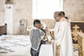 Bohol, Philippines - A priests gives communion to a newly wed couple. A typical Roman Catholic wedding