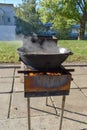 Boil the broth with meat and vegetables in a cauldron. Cooking shurpa soup over an open fire. Royalty Free Stock Photo