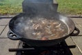 Boil the broth with meat and vegetables in a cauldron. Cooking shurpa soup over an open fire. Royalty Free Stock Photo