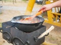 Boil the broth with meat and vegetables in a cauldron. Cooking shurpa soup over an open fire Royalty Free Stock Photo