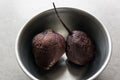 Boiled beets in a metal dish on a light background