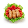 Boiled big sausages with tomato and green salad. Royalty Free Stock Photo