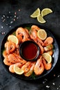 Cooked large shrimps with lemon, dill and tomato sauce. Healthy food. Top view. Royalty Free Stock Photo