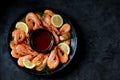 Cooked large shrimps with lemon, dill and tomato sauce. Healthy food. Top view. Royalty Free Stock Photo