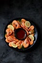 Cooked large shrimps with lemon, dill and tomato sauce. Healthy food. Top view. Royalty Free Stock Photo