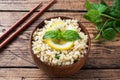 Boiled bulgur with fresh lemon and mint on a plate. A traditional oriental dish called Tabouleh. wooden background rustic