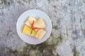 Boiled cassava is better than fried, cassava in white bowl on concrete floor