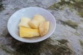 Boiled cassava is better than fried, cassava in white bowl on concrete floor