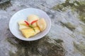 Boiled cassava is better than fried, cassava in white bowl isolated on concrete floor