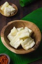 Boiled cassava on rustic bowl. Served with `sambal or chili sauce.1