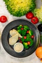 Boiled chicken breast with broccoli and tomatoes with sauce, healthy food in a white plate on a white table Royalty Free Stock Photo