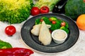 Boiled chicken breast with broccoli and tomatoes with sauce, healthy food in a white plate on a white table Royalty Free Stock Photo
