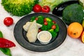 Boiled chicken breast with broccoli and tomatoes with sauce, healthy food in a white plate on a white table Royalty Free Stock Photo
