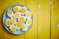 Boiled chicken eggs on a blue ceramic plate. The concept of Easter Holidays Royalty Free Stock Photo