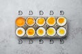 Boiled chicken eggs of readiness stages in carton on light grey table, top view Royalty Free Stock Photo