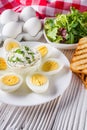 Boiled chicken eggs on a white wooden rustic background