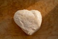 Boiled chicken fillet in the shape of a heart on an old wooden cutting board Royalty Free Stock Photo