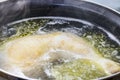 Boiled chicken in a pot broth close-up with blurred background and front Royalty Free Stock Photo