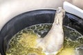 Boiled chicken in a pot broth close-up with blurred background and front Royalty Free Stock Photo