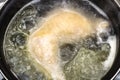Boiled chicken in a pot broth close-up with blurred background and front Royalty Free Stock Photo