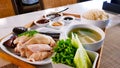 Ã Â¸ÂºBoiled chicken with rice steamed, soup fresh cucumber, green cabbage, sweet sauce on wooden tray. Royalty Free Stock Photo