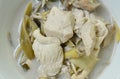 Boiled chicken with slice banana blossom in coconut milk soup on bowl Royalty Free Stock Photo