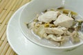 Boiled chicken with slice banana blossom in coconut milk soup on bowl