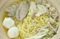 Boiled Chinese yellow egg noodles with entrails and fish ball in soup on bowl Royalty Free Stock Photo