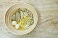 Boiled Chinese yellow egg noodles with entrails and fish ball in soup on bowl Royalty Free Stock Photo