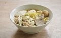 boiled Chinese yellow egg noodles with entrails and fish ball in soup on bowl Royalty Free Stock Photo